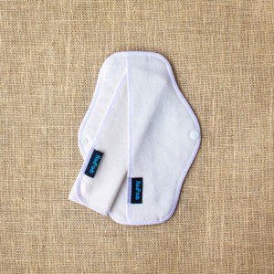 A natural hemp fleece reusable menstrual pad with a towel insert